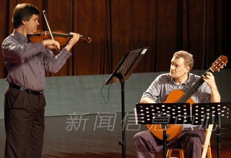 Eric Lawson, violin, and Jeff Anvinson, guitar, performing in China